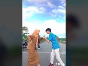 Berita viral dan trending terbaru: Seorang guru yang tengah berpakaian dinas berjoget Tiktok dengan siswanya sambil tatap-tatapan.