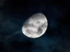 Bulan bersinar di balik lapisan awan tipis pada langit malam
