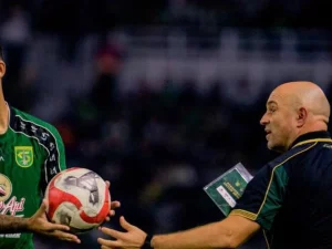 Pelatih kepala Persebaya Bernardo Tavares menyerahkan bola kepada pemainnya