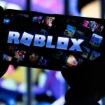 Seorang anak memainkan Roblox lewat telepon pintar