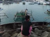Perahu-perahu nelayan bersandar rapat di perairan pelabuhan.