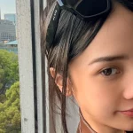 Anya Geraldine berswafoto dengan latar gedung dan pepohonan di Jepang