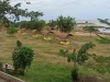 Pesisir Takisung di Kabupaten Tanah Laut dengan hamparan rumput dan laut di kejauhan.