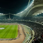 Stadion sepak bola penuh penonton saat malam hari