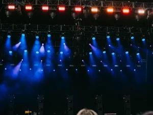 Penonton dan panggung konser dengan efek cahaya warna-warni