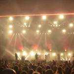 Band tampil di atas panggung dengan efek tata cahaya