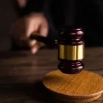 Palu sidang di atas meja kayu
