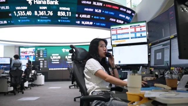 Dealer mata uang memantau nilai tukar di ruang perdagangan valuta asing kantor pusat Hana Bank, Seoul