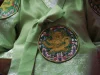 Detail kain hanbok hijau dengan bordir lingkaran bermotif naga.