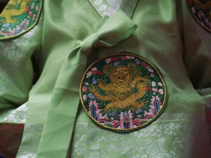 Detail kain hanbok hijau dengan bordir lingkaran bermotif naga.