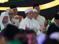Menteri Agama dan sejumlah tokoh berpakaian putih menengadahkan tangan memanjatkan doa bersama di atas panggung