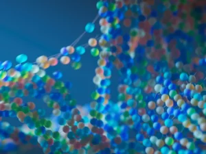 Ilustrasi model molekul berwarna biru dan ungu yang berpendar.