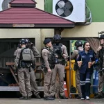 Polisi bersenjata berjaga di depan Sekolah Debsirin Nonthaburi, Distrik Bang Kruai, Thailand, lokasi penembakan yang menewaskan tujuh orang