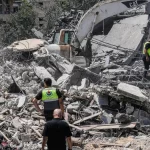 Petugas penyelamat memeriksa reruntuhan rumah yang hancur akibat serangan Israel di Lebanon selatan