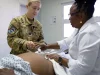 Petugas medis militer Amerika Serikat melakukan pemeriksaan kehamilan (antenatal care) pada pasien di Sandy Point, St. Kitts