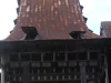 Atap menjulang dan fasad kayu berukir rumah adat Omo Nifolasara di Bawomataluo, Nias Selatan