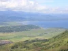 Hamparan sawah, permukiman, dan Danau Kerinci dilihat dari lereng Bukit Kayangan