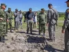 Menteri Pertahanan Kolombia Jorge Mora meninjau lokasi serangan drone pemberontak di sebuah garnisun militer di Ocana.
