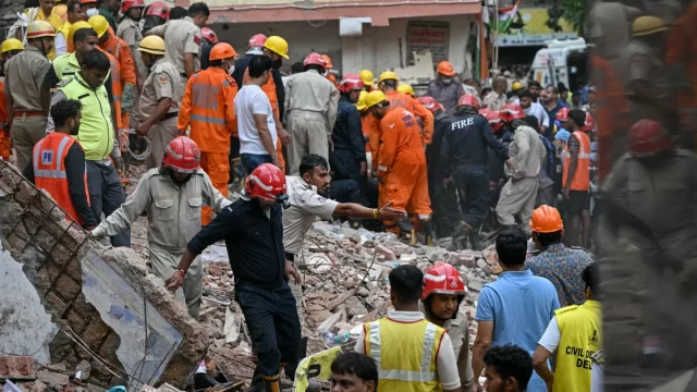 Petugas penyelamat mencari korban di lokasi gedung ambruk kawasan Satya Niketan, New Delhi