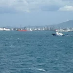 Deretan tangki, cerobong, dan dermaga kawasan industri pesisir Cilegon dilihat dari laut