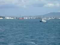 Deretan tangki, cerobong, dan dermaga kawasan industri pesisir Cilegon dilihat dari laut