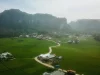 Pemandangan udara bukit-bukit karst, sawah, dan permukiman di kawasan Rammang-Rammang