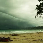 Awan badai menggantung di atas Pantai Lasikin, Pulau Simeulue, dengan perahu di pasir