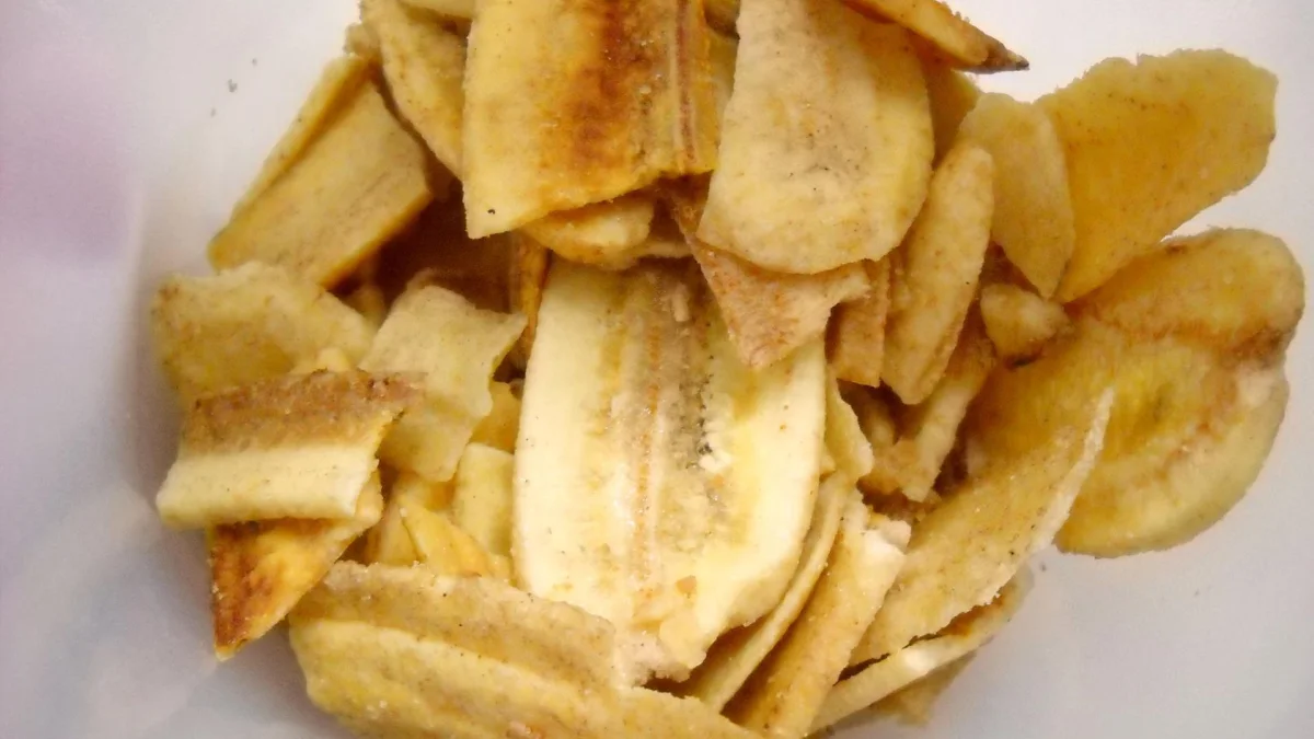 Keripik pisang khas Lampung berwarna kuning keemasan menumpuk di dalam wadah