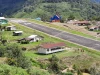 Lapangan terbang perintis dan permukiman beratap seng di lembah Kiwirok, Pegunungan Bintang, Papua