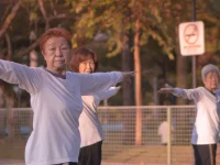 Tiga lansia berlatih taichi pagi hari di sebuah taman di Singapura