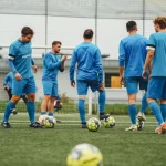 Sekelompok pemain sepak bola berlatih di lapangan rumput