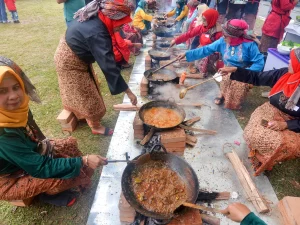 Tradisi marandang, ibu-ibu memasak rendang daging dalam kuali di Sumatera Barat