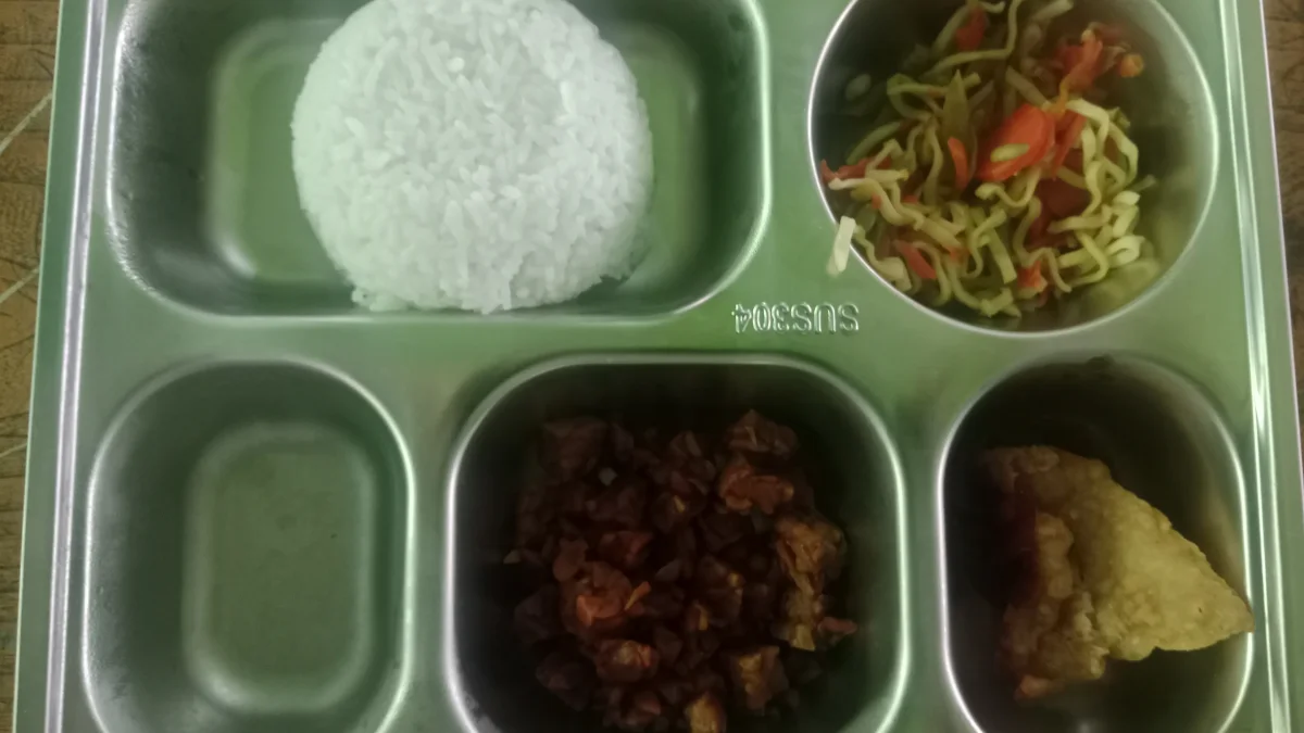Ompreng baja berisi nasi, mi bersayur, lauk, dan gorengan dari program Makan Bergizi Gratis