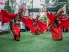 Penari Gandrung Banyuwangi berkostum merah menari di panggung terbuka.