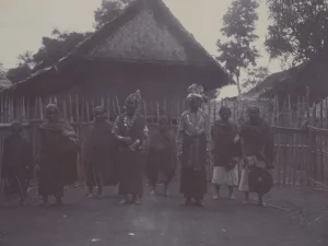 Pasangan pengantin berdiri bersama sejumlah orang di depan rumah beratap tinggi di Laut Tawar
