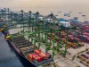 Kapal kargo bersandar di bawah deretan derek terminal peti kemas Jakarta Utara