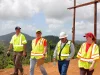 Petugas berompi keselamatan meninjau pemulihan jaringan listrik dengan tiang baru di Puerto Rico