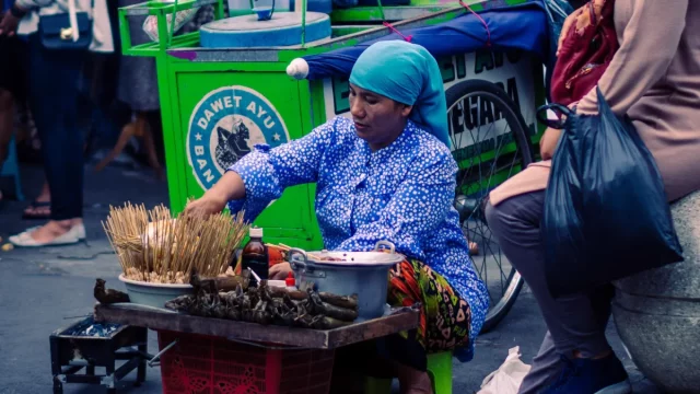 Ilustrasi penjual jajanan kaki lima membakar dagangannya di pinggir jalan