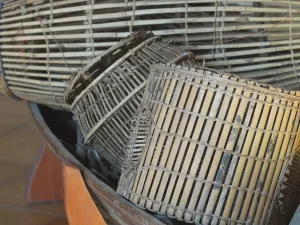 Bubu anyaman bambu di dalam perahu kayu koleksi suku Sakai dan Bonai Riau