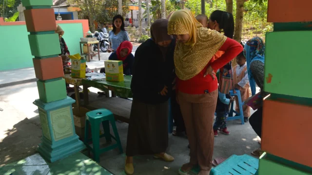 Kader posyandu memeriksa dan menimbang balita pada kegiatan posyandu di Desa Kanoman.