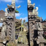 Ilustrasi gapura batu berukir di sebuah pura di Bali.