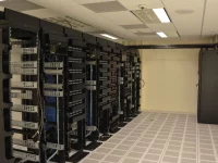 Deretan rak server berisi perangkat jaringan di dalam ruang pusat data