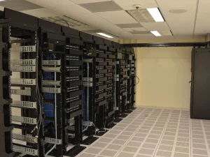 Deretan rak server berisi perangkat jaringan di dalam ruang pusat data