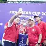 Ketua Umum PSSI Erick Thohir berswafoto di samping trofi FIFA ASEAN Cup 2026 di Jakarta