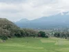 Hamparan sawah hijau di kaki perbukitan berselimut awan, Manggarai Barat, Flores, Nusa Tenggara Timur