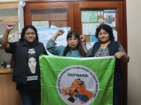 Anggota serikat pekerja rumah tangga SINTTRAHOL membentangkan bendera serikat di Lima, Peru