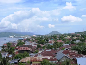 Atap-atap rumah Kota Ternate dengan teluk dan gunung di kejauhan