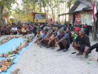 Warga duduk berjajar di depan sajian tradisi Gumbregan masyarakat Samin Margomulyo