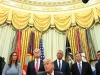 Donald Trump duduk dikelilingi sejumlah pejabat berjas gelap di Ruang Oval Gedung Putih