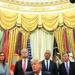 Donald Trump duduk dikelilingi sejumlah pejabat berjas gelap di Ruang Oval Gedung Putih